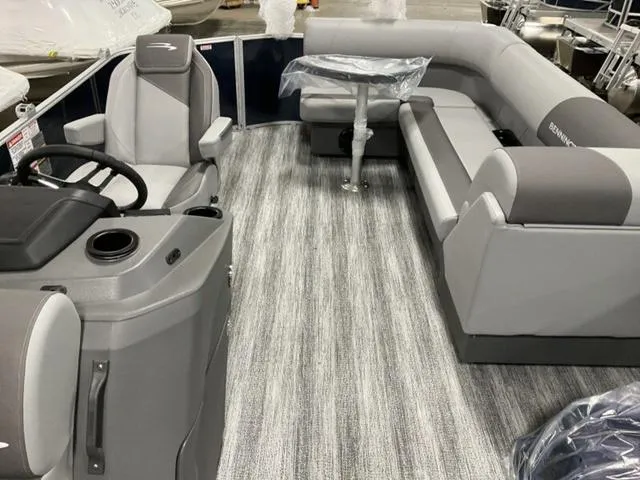 Slide: The Image of 2025 Bennington S L-Bench 21 SLJ pontoon boat interior with gray seating and steering console. - 6