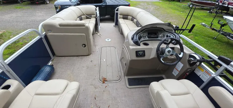 Slide: The Image of 2022 Sun Tracker PB 22 XP3 pontoon boat with beige seating and modern dashboard. - 10