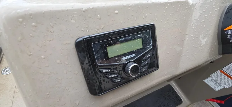 Slide: The Image of Kicker media center on 2022 Sun Tracker PB 22 XP3 boat, wet with raindrops. - 11