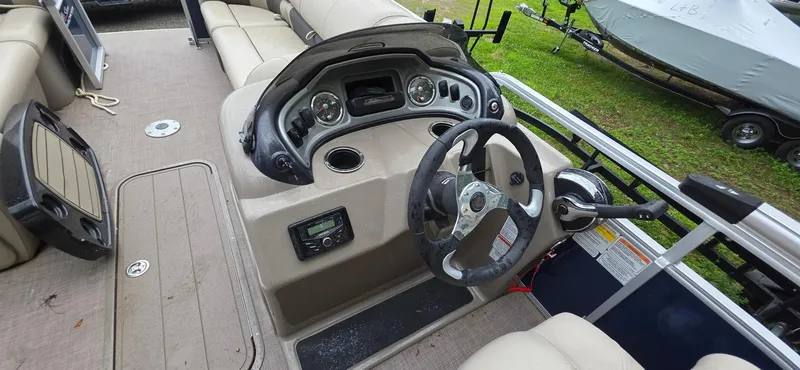 Slide: The Image of Interior view of a 2022 Sun Tracker PB 22 XP3 pontoon boat's steering console. - 12