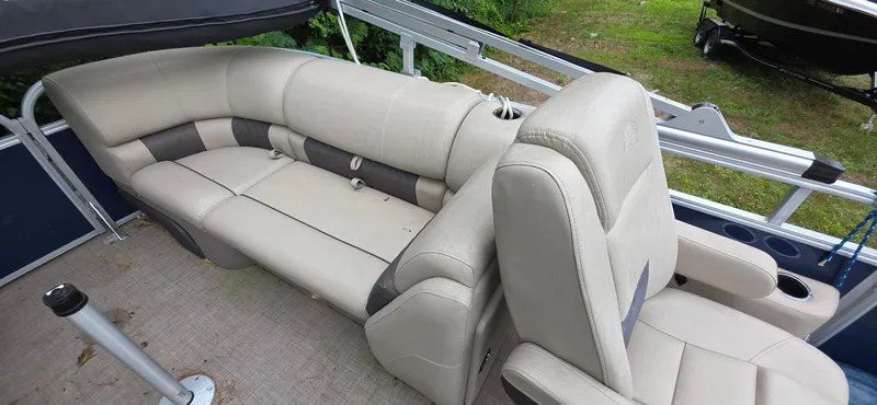 Slide: The Image of 2022 Sun Tracker PB 22 XP3 pontoon boat with beige seating and cup holders. - 13