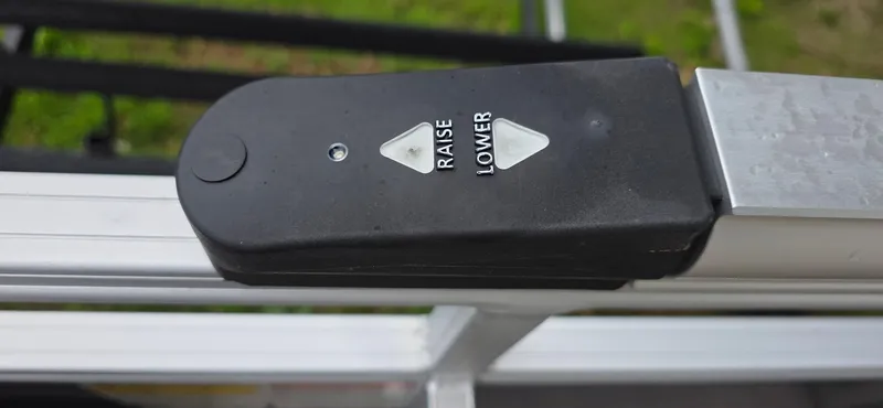 Slide: The Image of Control panel on a 2022 Sun Tracker PB 22 XP3 boat, featuring raise and lower buttons. - 14