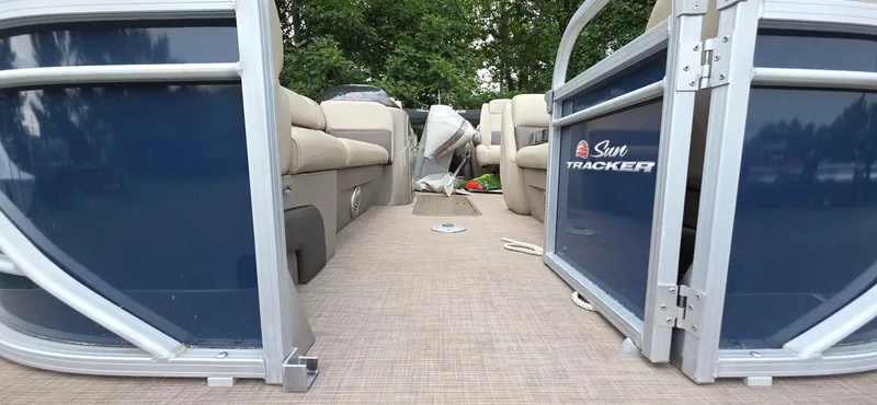 Slide: The Image of 2022 Sun Tracker PB 22 XP3 pontoon boat interior with beige seating and blue exterior panels. - 6