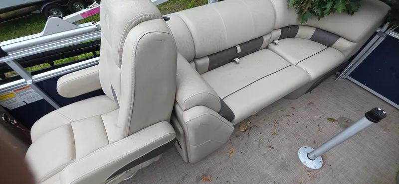 Slide: The Image of 2022 Sun Tracker PB 22 XP3 boat interior with beige seating and carpeted floor. - 9