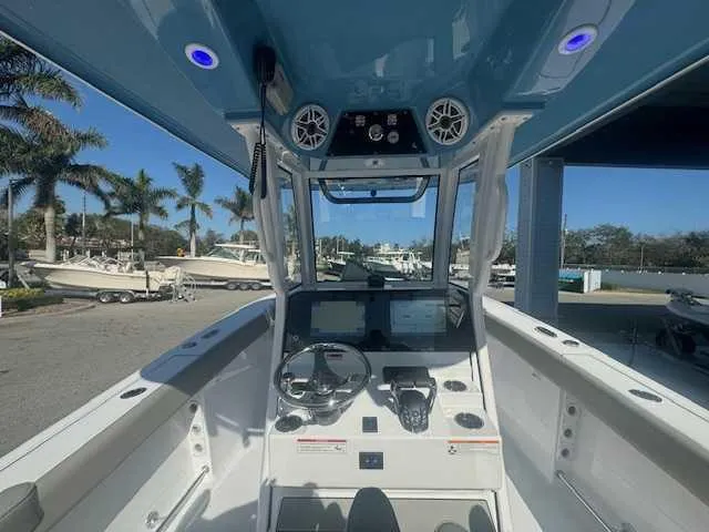 Slide: The Image of 2025 Sportsman Heritage 261 boat with dual cushioned seats on deck. - 22