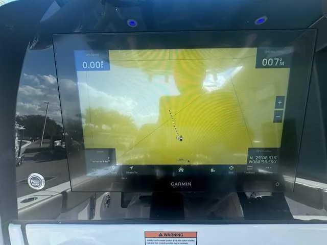 Slide: The Image of 2025 Sportsman Heritage 261 boat dashboard with dual navigation screens. - 25