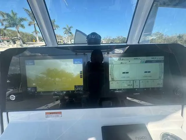 Slide: The Image of 2025 Sportsman Heritage 261 boat dashboard with wireless charging pad. - 26