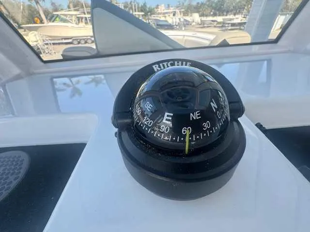 Slide: The Image of 2025 Sportsman Heritage 261 boat detail, featuring a built-in wireless charging pad. - 28