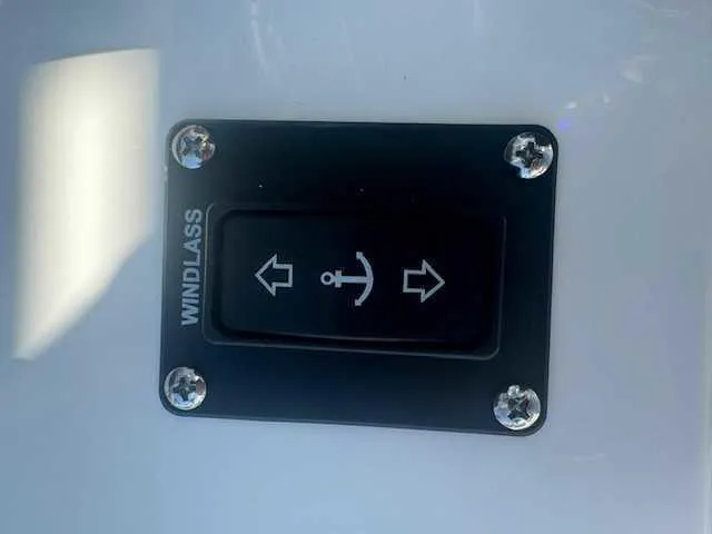 Slide: The Image of 2025 Sportsman Heritage 261 boat throttle control with start button and chrome accents. - 32