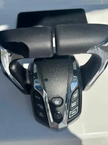 Slide: The Image of 2025 Sportsman Heritage 261 boat throttle control with start button and chrome accents. - 33