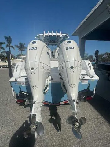 Slide: The Image of 2025 Sportsman Heritage 261 boat interior with seating and console, docked outdoors. - 37