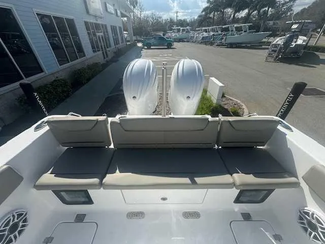 Slide: The Image of 2025 Sportsman Heritage 261 boat interior with dual seats and overhead rod holders. - 43