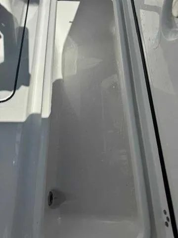 Slide: The Image of 2025 Sportsman Heritage 261 boat interior, featuring seating and cup holders. - 46