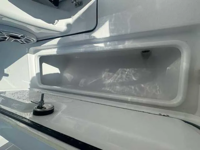 Slide: The Image of 2025 Sportsman Heritage 261 boat interior with seating and storage compartments. - 48