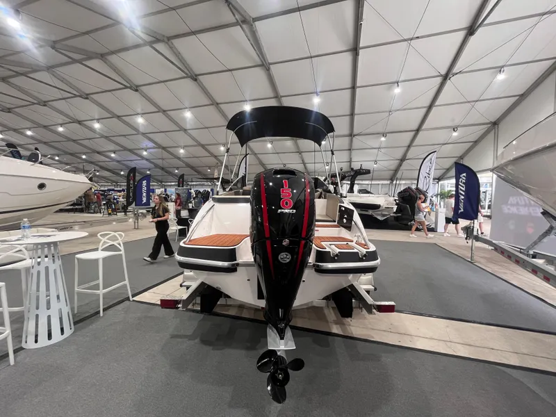 Slide: The Image of 2025 Ventura 195 Crossover boat displayed at an indoor exhibition, showcasing sleek design and modern features. - 13
