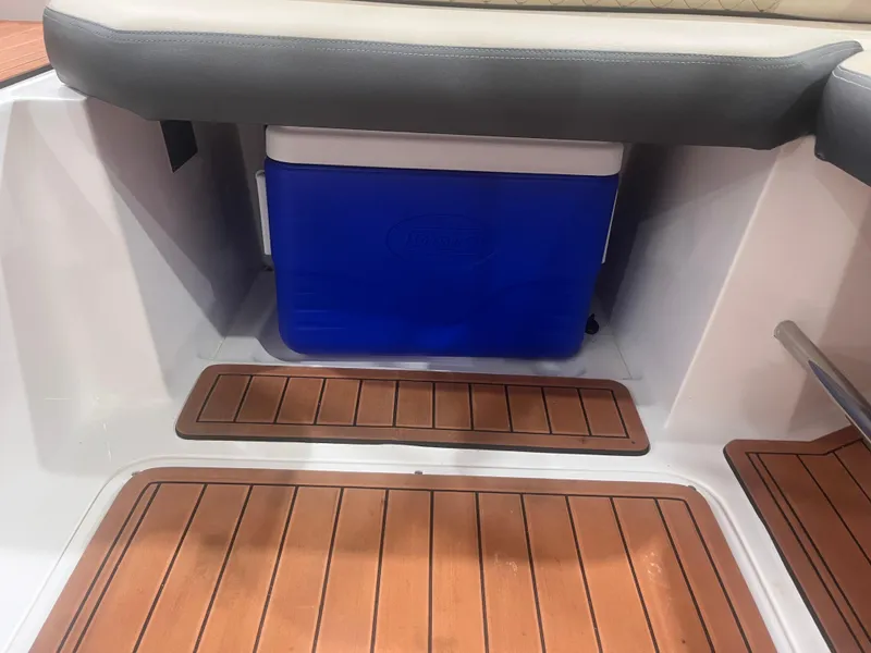 Slide: The Image of 2025 Ventura 195 Crossover boat interior with blue cooler and wooden flooring. - 15