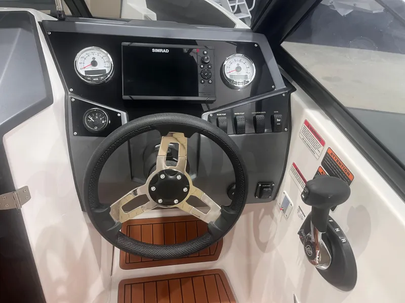 Slide: The Image of 2025 Ventura 195 Crossover boat dashboard with steering wheel and control panel. - 22