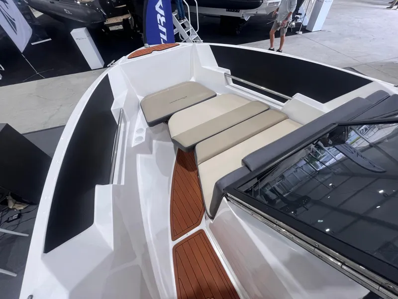 Slide: The Image of 2025 Ventura 195 Crossover boat interior with cushioned seating and sleek design. - 35