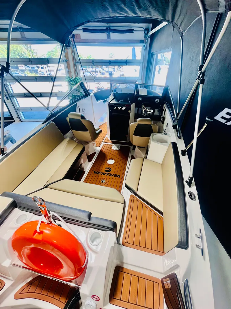 Slide: The Image of 2025 Ventura 195 Crossover boat interior with seating, steering console, and life preserver. - 53