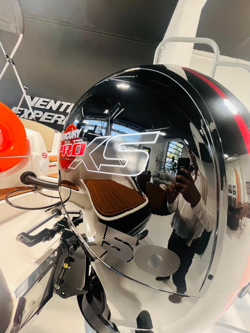 Slide: The Image of 2025 Ventura 195 Crossover with Mercury Pro XS 150 outboard engine, sleek and modern design. - 54