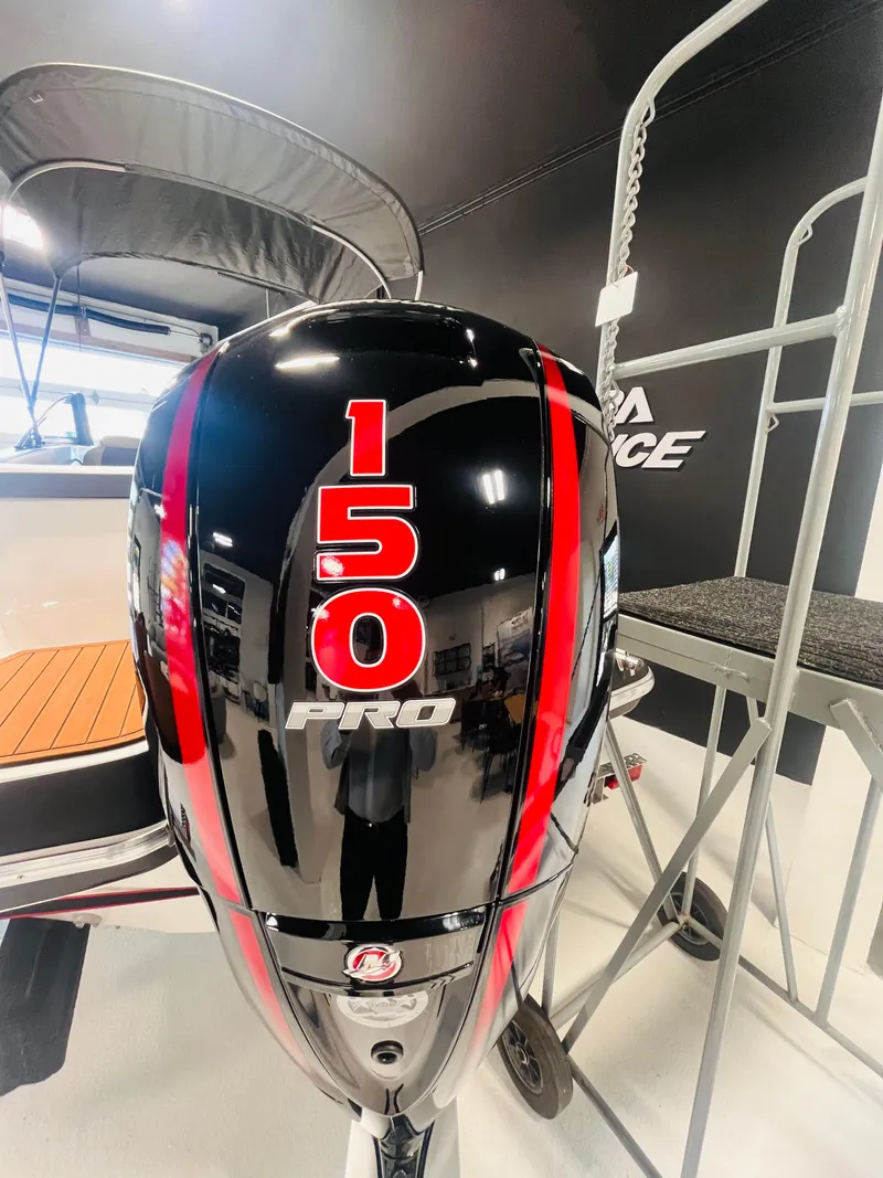 Slide: The Image of 2025 Ventura 195 Crossover with 150 Pro outboard motor in showroom. - 55