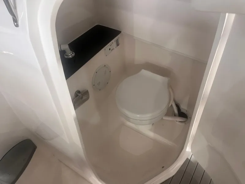 Slide: The Image of Compact bathroom in 2025 Ventura 252 Comfort boat, featuring a modern toilet and sink. - 8