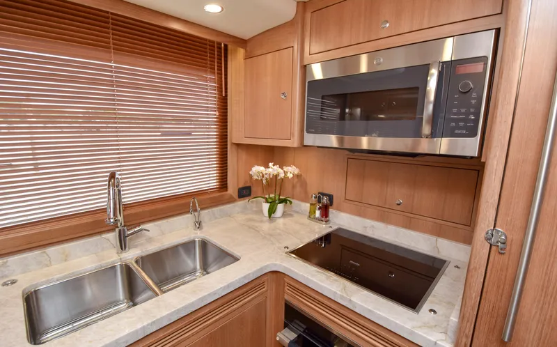 Slide: The Image of Modern kitchen in 2020 Fleming 78 yacht with stainless steel appliances and wooden cabinetry. - 10