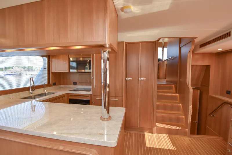 Slide: The Image of Luxurious interior of 2020 Fleming 78 yacht featuring modern kitchen and wooden finishes. - 11