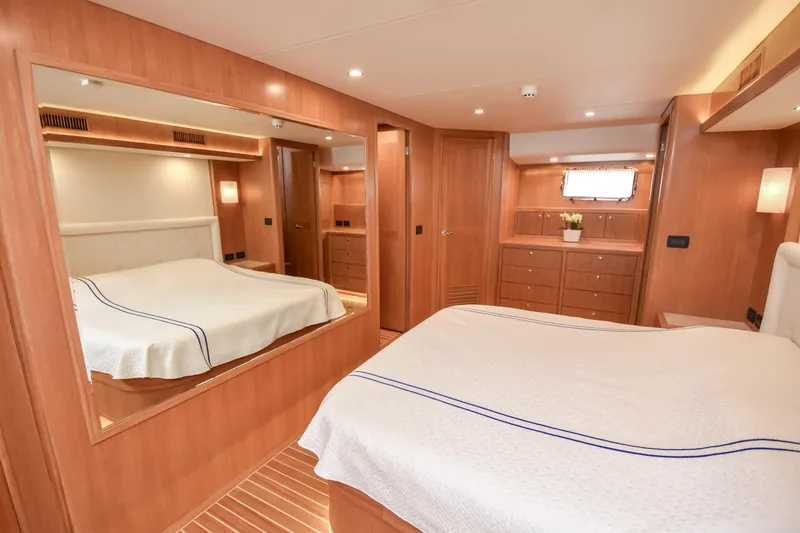 Slide: The Image of Luxurious cabin interior of 2020 Fleming 78 yacht with elegant wood finish and cozy bedding. - 13
