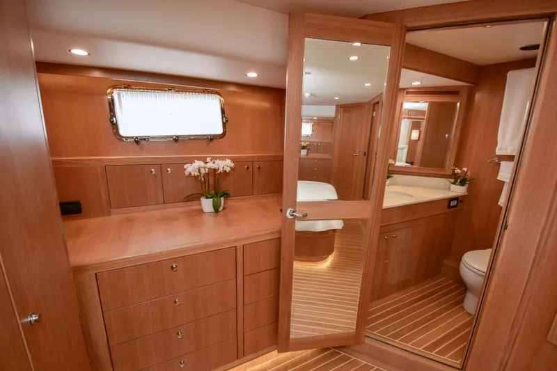 Slide: The Image of Luxurious bathroom interior on a 2020 Fleming 78 yacht, featuring wood cabinetry and elegant design. - 14