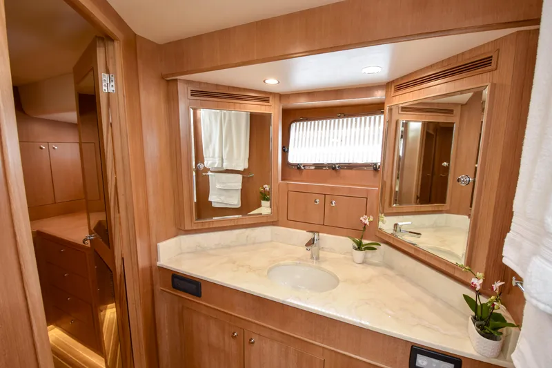 Slide: The Image of Luxurious bathroom in 2020 Fleming 78 yacht with wood accents and marble countertop. - 15
