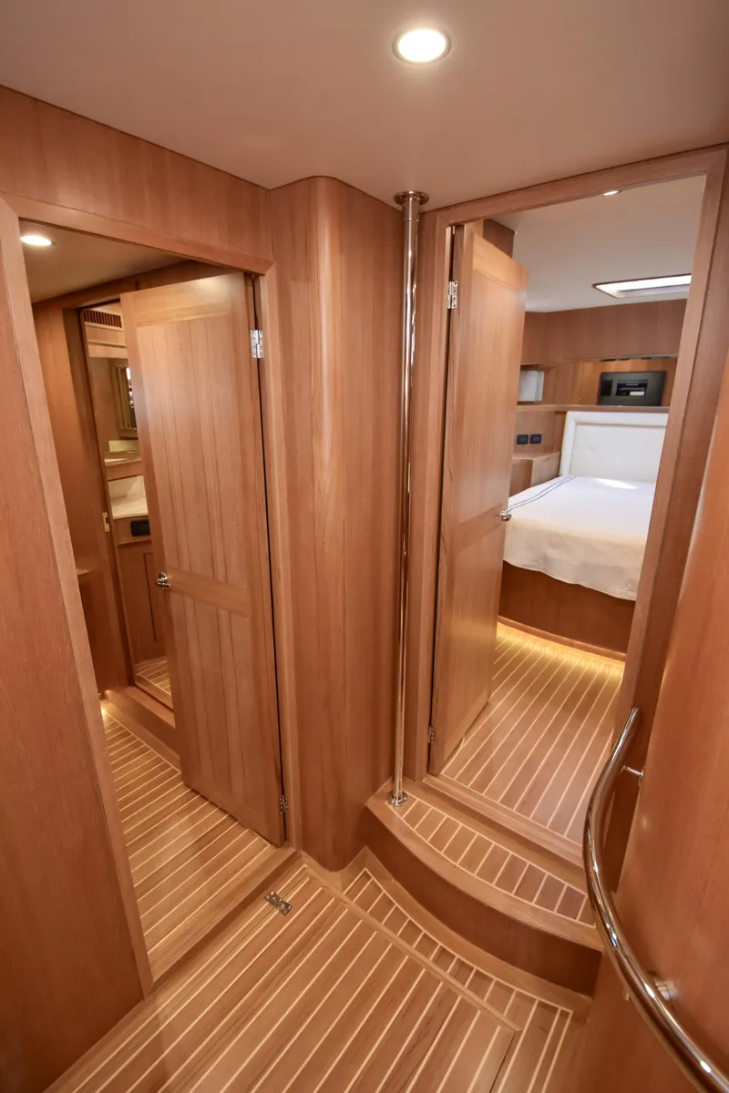 Slide: The Image of Luxurious wood interior of 2020 Fleming 78 yacht, featuring elegant cabin and hallway design. - 18