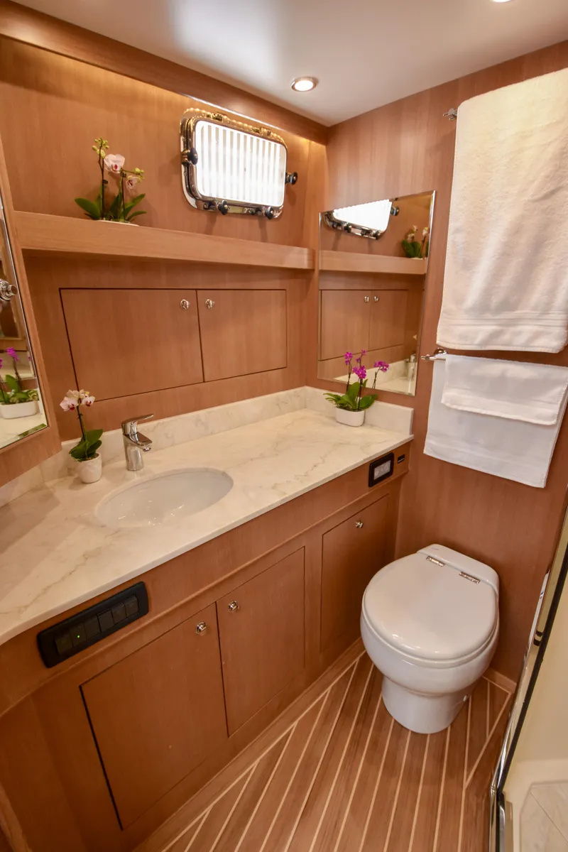 Slide: The Image of Luxurious bathroom in 2020 Fleming 78 yacht with wood accents and modern fixtures. - 21