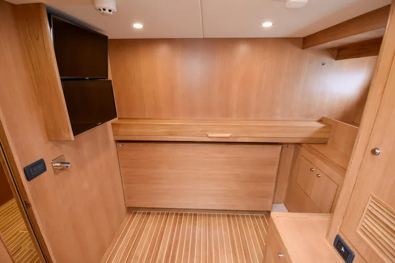 Slide: The Image of Luxurious wood interior of 2020 Fleming 78 yacht cabin with modern amenities. - 22