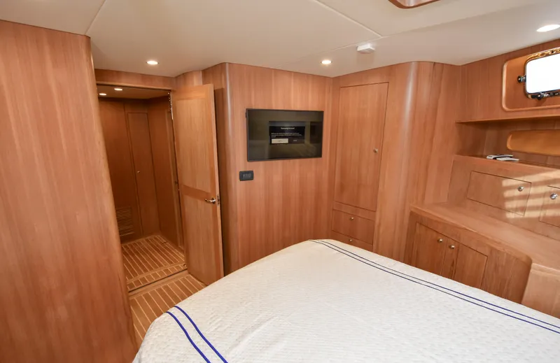 Slide: The Image of Luxurious cabin interior of 2020 Fleming 78 yacht with wood paneling and modern amenities. - 24