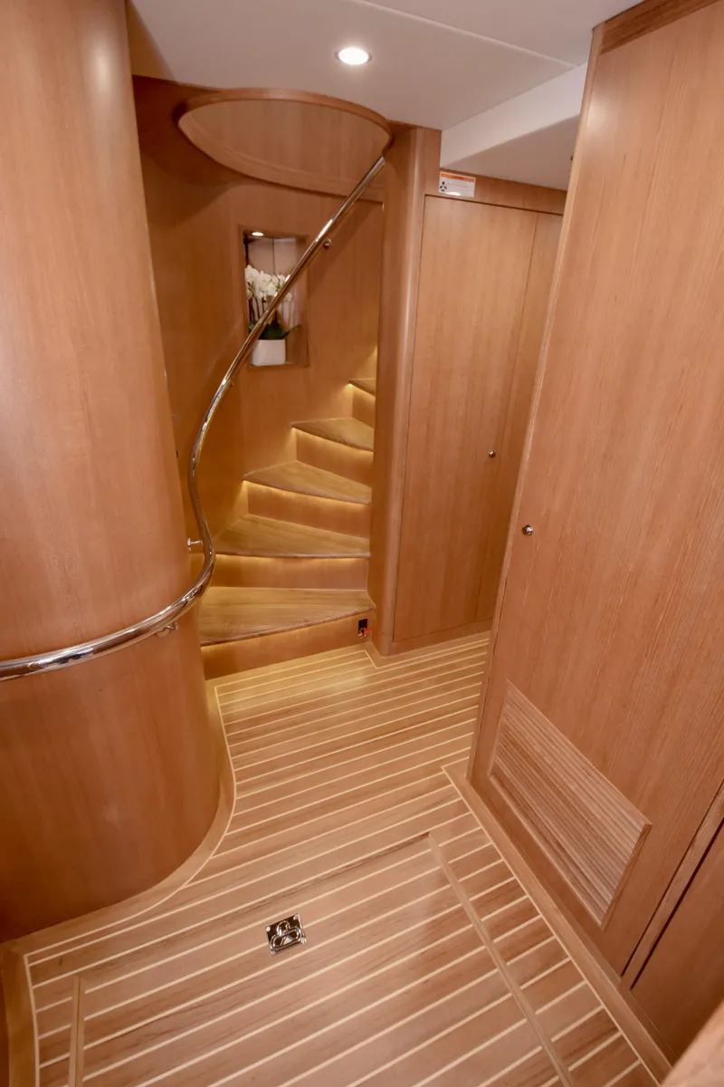 Slide: The Image of Luxurious wooden interior of 2020 Fleming 78 yacht with spiral staircase. - 27