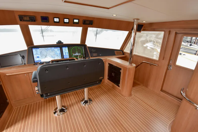 Slide: The Image of Pilothouse interior of 2020 Fleming 78 yacht with navigation screens and wooden finish. - 29