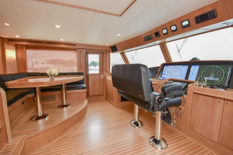 Slide: The Image of Luxurious 2020 Fleming 78 yacht interior with helm, navigation screens, and elegant seating area. - 30