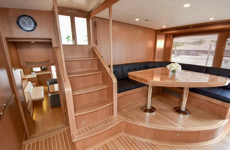 Slide: The Image of Luxurious interior of 2020 Fleming 78 yacht with wooden finishes and elegant seating area. - 32