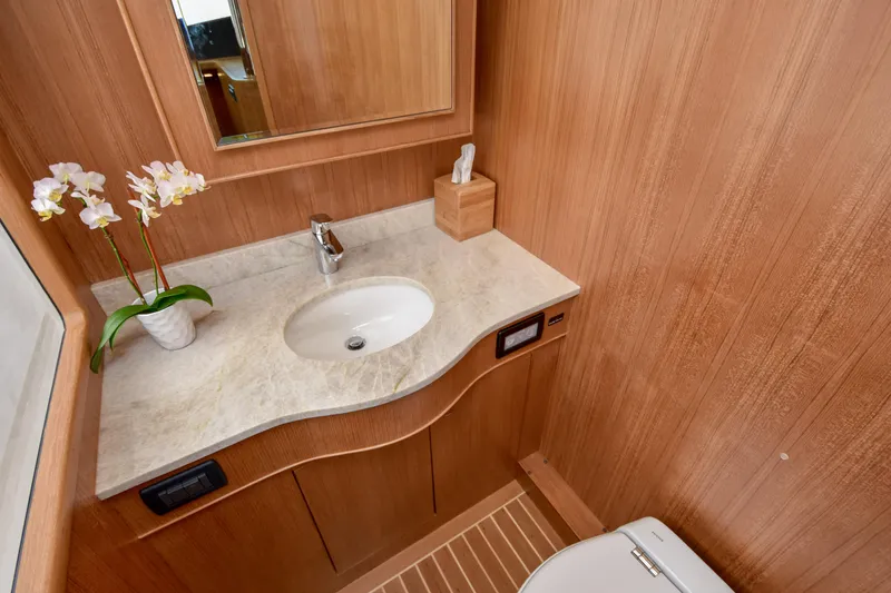Slide: The Image of Luxurious wooden bathroom interior on a 2020 Fleming 78 yacht with elegant sink and decor. - 34