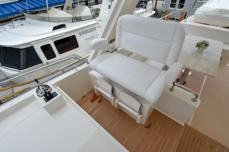Slide: The Image of Luxury seating on 2020 Fleming 78 yacht deck with control panel. - 38