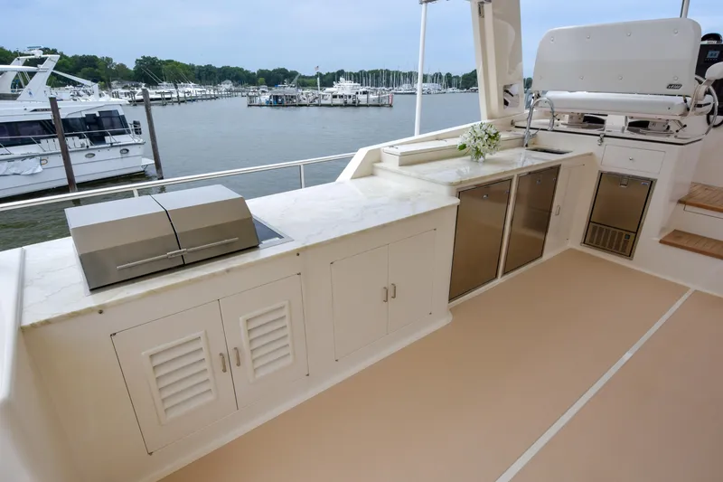 Slide: The Image of Outdoor kitchen on 2020 Fleming 78 yacht with grill, cabinets, and marina view. - 41