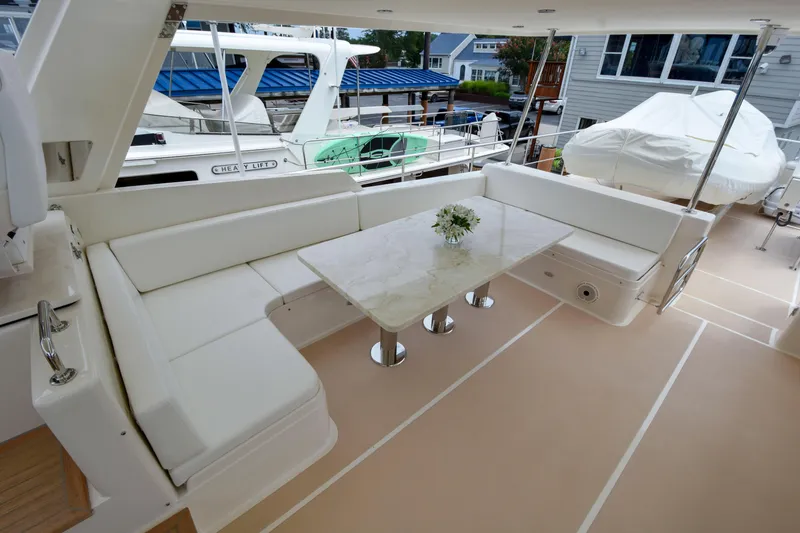 Slide: The Image of Luxurious 2020 Fleming 78 yacht deck with elegant seating and table arrangement. - 42
