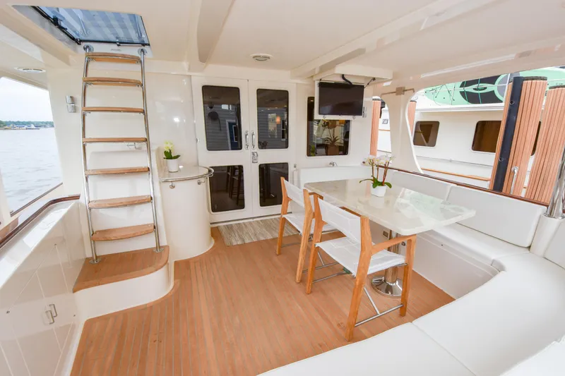 Slide: The Image of Luxurious Fleming 78 yacht deck with seating, table, and ladder, 2020 model. - 49