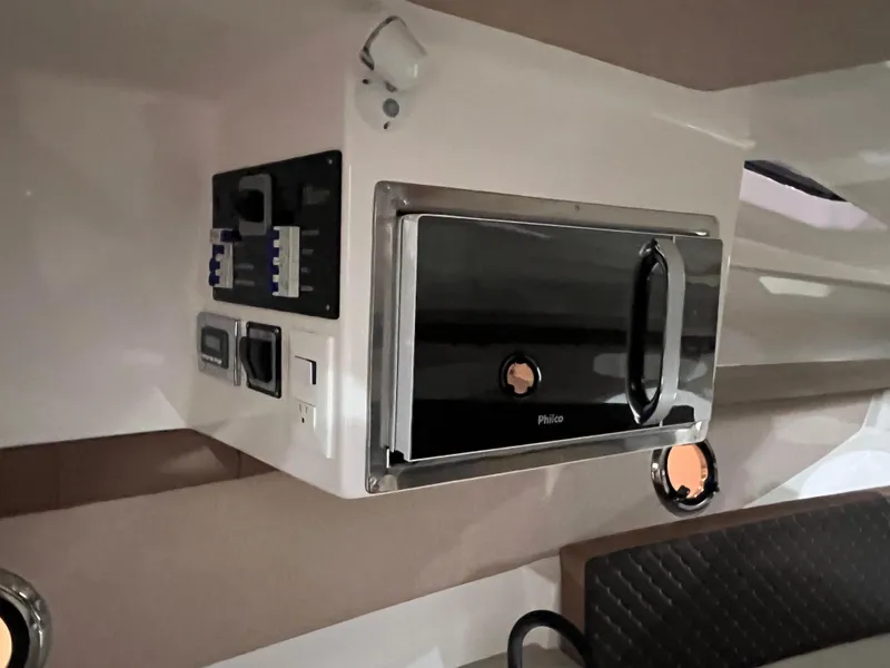 Slide: The Image of Interior of 2025 Ventura DayCruiser featuring a modern microwave and control panel. - 11