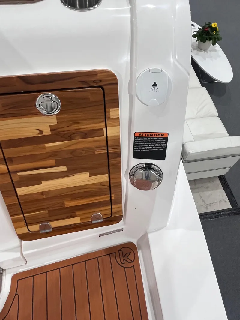 Slide: The Image of 2025 Ventura DayCruiser boat interior with wood accents and modern design. - 14