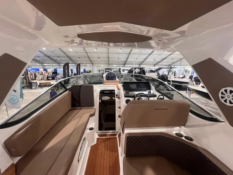 Slide: The Image of 2025 Ventura DayCruiser interior with modern seating and dashboard at a boat show. - 5