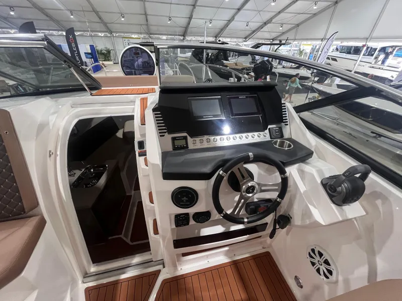 Slide: The Image of 2025 Ventura DayCruiser cockpit with modern controls and sleek design in a showroom setting. - 7