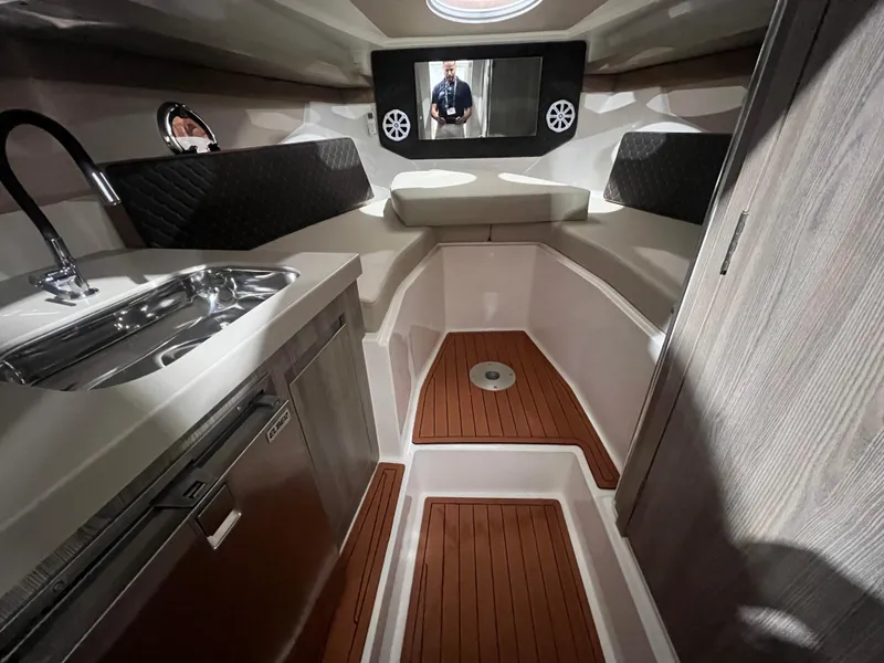 Slide: The Image of 2025 Ventura DayCruiser interior with kitchenette, wood flooring, and modern design. - 8