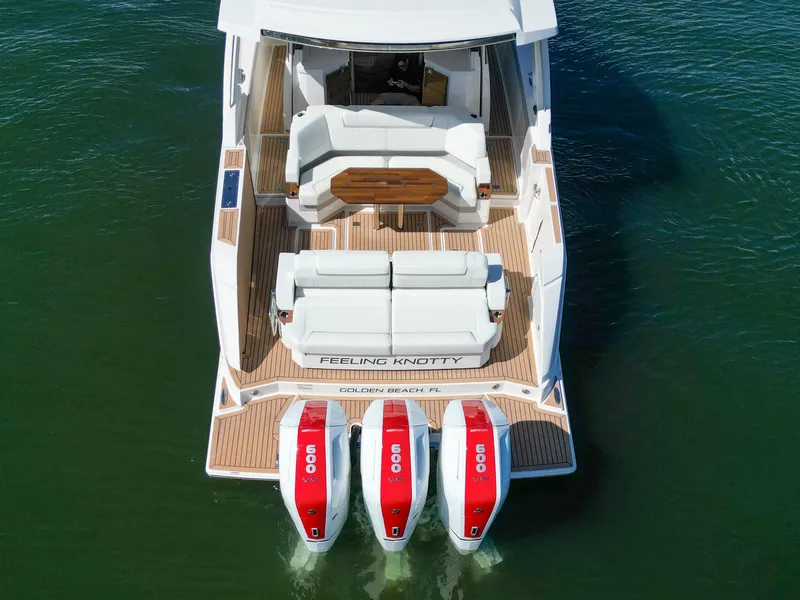 Slide: The Image of 2023 Tiara Yachts 48 LS with triple 600 HP engines, rear view on water. - 10